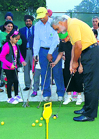 President of the Chandigarh Golf Club Gurinderjit Sandhu strikes a shot at an artificial putting green in Chandigarh