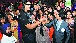 Wrestler Rajesh Kumar interacts with students during a farewell party at GGDSD College in Sector 32, Chandigarh, on Friday