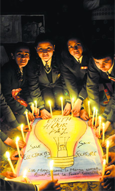 Schoolchildren hold lighted candles during an Earth Hour campaign in Shimla on Friday. Earth Hour will be observed on Saturday between 8.30 and 9.30 pm.
