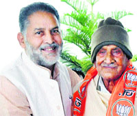 State BJP president Ram Bilas Sharma welcomes former Chief Minister Hukam Singh into the partyfold in Chandigarh on Friday. 