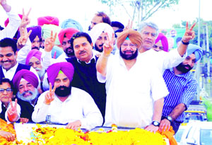Congress candidate Capt Amarinder Singh with his supporters during a road show in Amritsar on Friday.