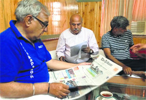 Haryana CM Bhupinder Singh Hooda reads The Tribune.