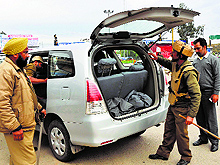 Police personnel check a car near Satwari Chowk in Jammu on Friday after the terrorist attack in Kathua