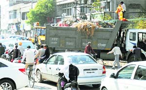 A truck parked on a road to lift garbage from a dump outside the Khalsa College for Women in Ludhiana. 