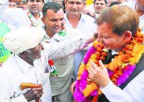 Congress leader Arvind Sharma being greeted by an elderly man in Karnal