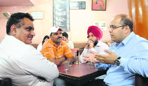 Friends discuss the poll scene at Indian Coffee House in Sector 17.