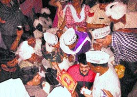 AAP volunteers present a plaque of Swami Vivekanand to former Arvind Kejriwal in Jind on Friday night