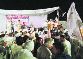 AAP leaders try to convince workers to wait for Arvind Kejriwal and not leave the rally venue in Jind on Friday night
