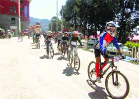 Children take part in the cycle rally organised to mark Earth Hour in Shimla on Saturday