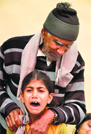 Daughter Simranjit Kaur and father Thoru Ram remain inconsolable during his cremation at Kotli Mirdian village in RS Pura.