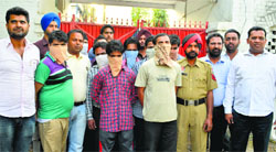 Nine members of the gang in police custody in Ludhiana on Saturday. Photo: Inderjeet Verma