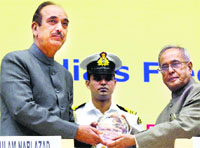 President Pranab Mukherjee presents a memento to Health Minister Ghulam Nabi Azad in New Delhi on Saturday. PTI