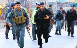 Policemen run towards the site of attack in Kabul on Saturday. AFP