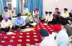 Members of the Khalsa Diwan hold a meeting at its office in Amritsar on Friday to pass the annual budget