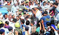 AAP leader Arvind Kejriwal and party candidate Gul Panag interact with people during a roadshow in Chandigarh on Sunday