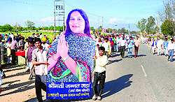 Party supporters carry a cutout of BSP candidate Jannat Jahan after Mayawatis rally in Sector 25, Chandigarh, on Sunday