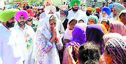 Congress candidate Ambika Soni interacts with residents at Bakerpur village in Mohali on Sunday