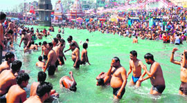 Devotees take a holy dip in the Ganga on the occasion of Phalgun Amavasya in Haridwar on Sunday.