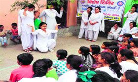 Volunteers perform a skit as part of an NSS camp in Haridwar on Sunday.