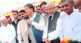 Chief Minister Harish Rawat addresses an election rally at Someshwar in Almora on Sunday.
