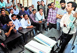 Poll staff being trained how to use electronic voting machines in Jammu on Sunday