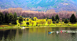 Tourists enjoy a boat ride at the Botanical Garden in Srinagar