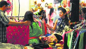 Women check apparels during an exhibition “Paris Street” in Ludhiana on Sunday.