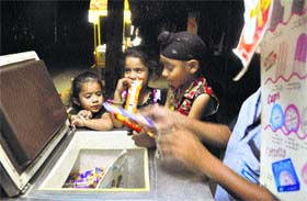 Children buy ice candies in Ludhiana.