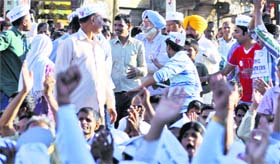 AAP candidate HS Phoolka (in blue turban) meets supporters in Ludhiana on Sunday.