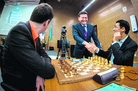 FIDE president Kirsan Ilyumzhinov (centre) congratulates Vishwanathan Anand on his overall triumph in the Candidates tournament during Anands 14th round match against Peter Svidler on Sunday. photo courtesy: