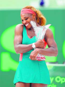 Serena Williams hugs the Butch Buchholz trophy after her win over Li Na in the final of the Sony Open in Miami late on Saturday.