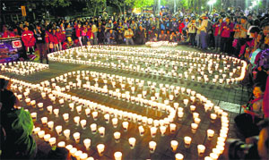 Candles placed by participants to create the number 60, representing the minutes in an hour, marking Earth Hour in La Paz, Bolivia