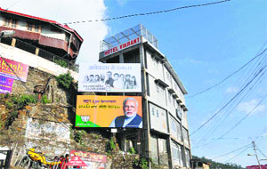 Election hoardings of different political parties placed at the old bus stand in Shimla on Monday.