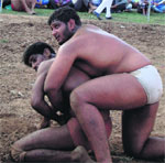 Wrestlers in action during a competition held at Moori in Katra on Monday. A Tribune photograph