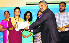 Arun Gupta, chairman of the Institute of Public Opinion, presents a prize to a winner of a debate in Jammu. A Tribune photograph