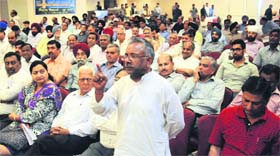 A trader poses a query to Congress candidate Pawan Bansal during an interaction in Chandigarh on Tuesday.