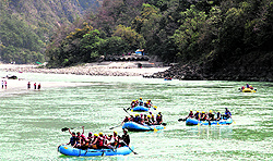 Rafters enjoy rafting in river Ganga at Rishikesh