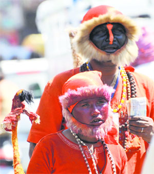 Dressed up as Lord Hanuman, a man and his son seek alms in Karnal on Tuesday.