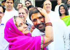 An old woman blesses Congress candidate Avtar Singh Bhadana during campaigning in Faridabad on Tuesday.