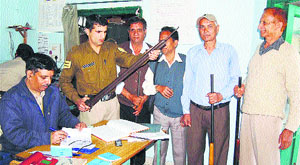 Residents submit their weapons at a police station in Dharamsala on Tuesday.