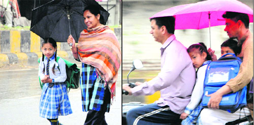A woman brings back her child from school in rain; (right) a man ferries his children to school during the rain in Amritsar on Wednesday