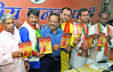 Dr Harsh Vardhan and other BJP candidates Maheish Girri, Pravesh Verma, Udit Raj, Manoj Tiwari, Ramesh Bidhuri and Meenakshi Lekhi, releasing the manifesto at the party office in New Delhi on Wednesday. 