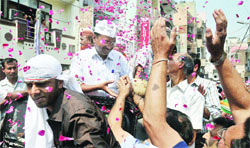 AAP leader Arvind Kejriwal meets supporters during a road show for the partys East Delhi candidate Rajmohan Gandhi, in East Delhi on Wednesday.