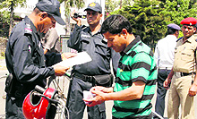 Policemen challan a motorcyclist for breaking breaking traffic rules in Dehradun on Wednesday