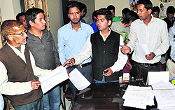 NSUI members submit their complaint against private schools at the Chief Education Officers office in Dehradun on Wednesday