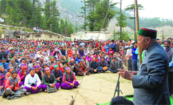Chief Minister Virbhadra Singh addresses a public meeting at Kupvi in Chaupal on Wednesday.
