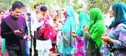 Congress candidate from Hamirpur Rajinder Rana being greeted by people at Bhareri on Wednesday. 
