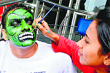 A student gets his face painted during the annual sports meet at BJS Dental College, Ludhiana, on Wednesday