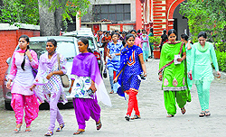College students come out of the examination centre after taking their annual exam of the Punjab University in Ludhiana on Wednesday