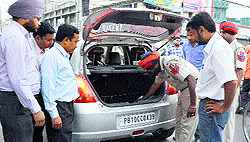 A surveillance team checks a vehicle near Domoria Bridge in Ludhiana
